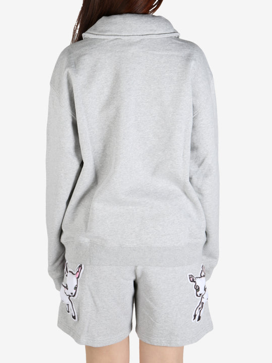 Grey knitwear worn by a person, showing the knitwear's fit