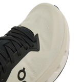 close up of white sneakers, showing texture of the recycled polyester fabric