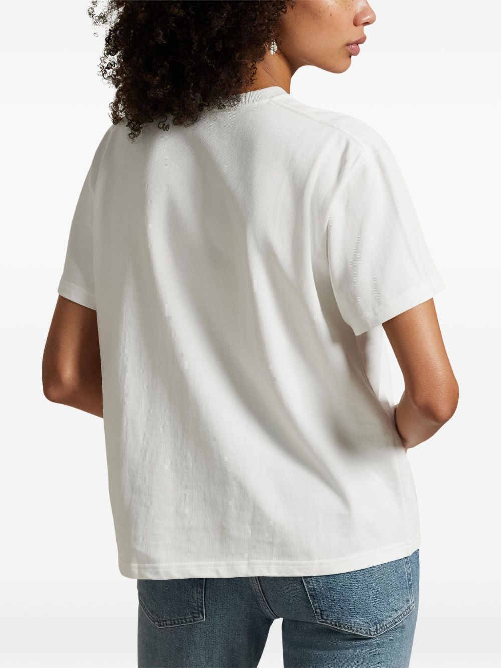 White t-shirt worn by a person, showing the t-shirt fit