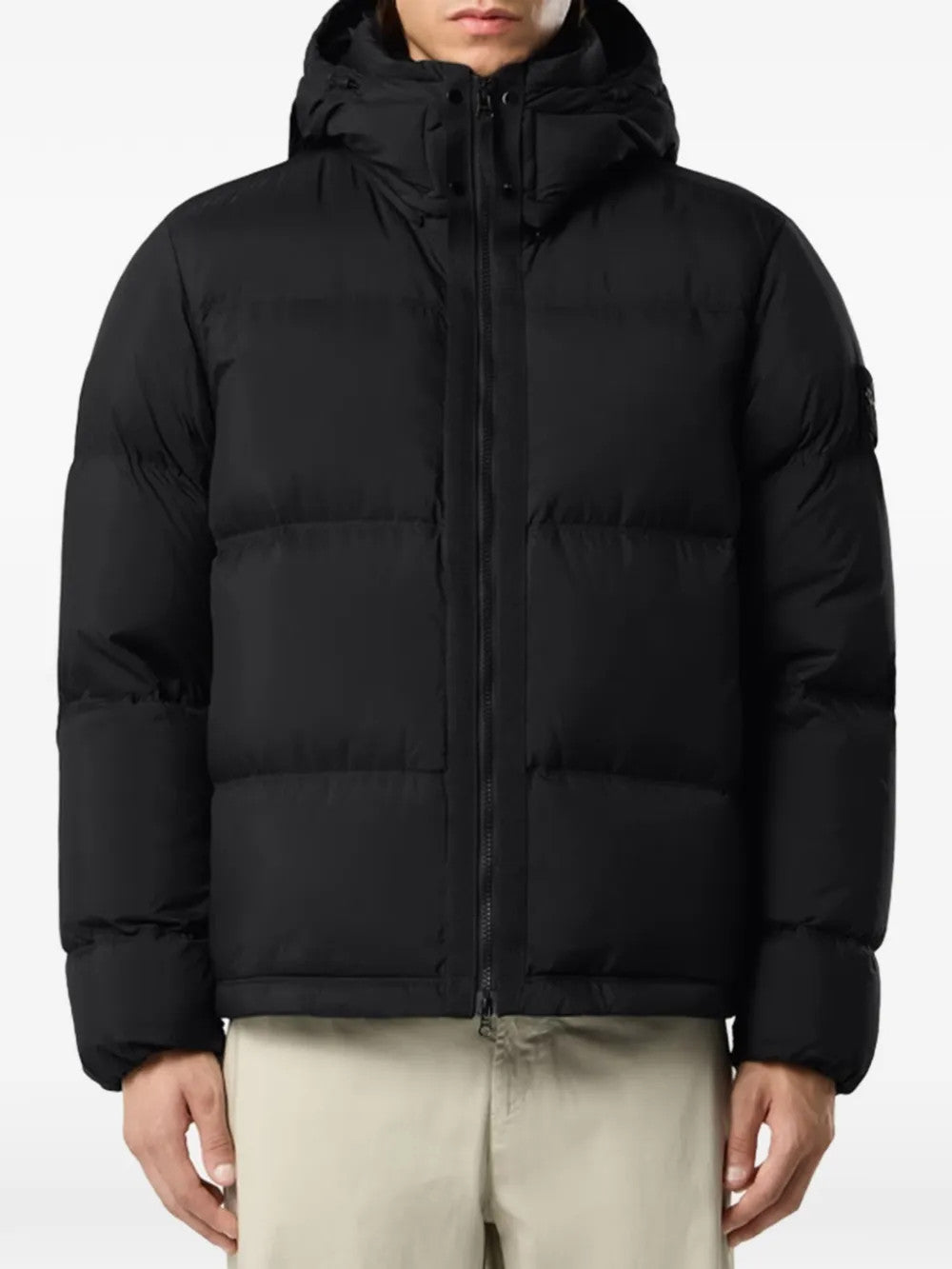 Black jacket worn by a person, showing the jacket fit