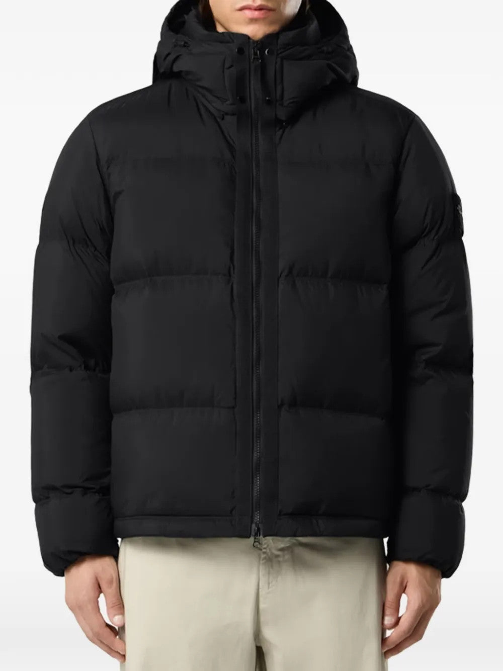 Black jacket worn by a person, showing the jacket fit