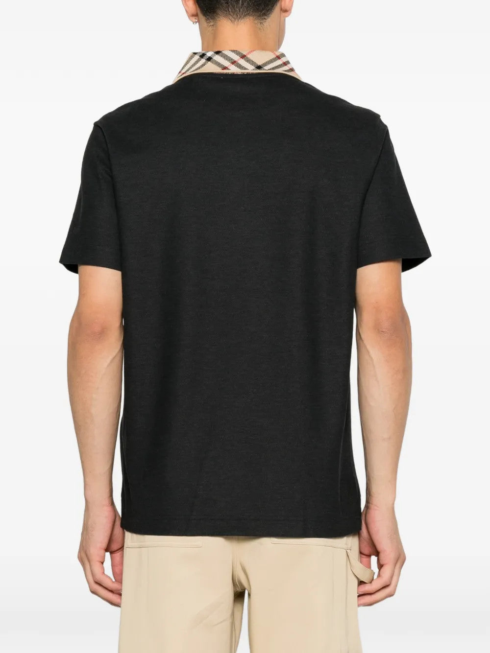 Black t-shirt worn by a person, showing the t-shirt fit