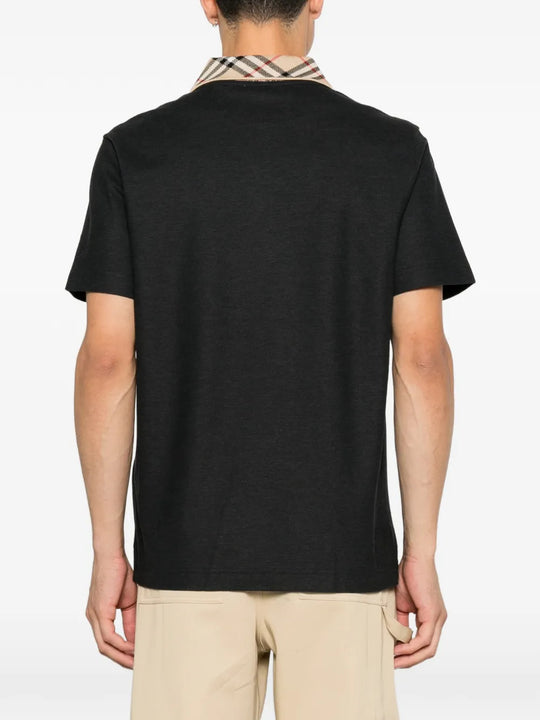 Black t-shirt worn by a person, showing the t-shirt fit