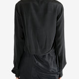 Black shirt worn by a person, showing the shirt's fit