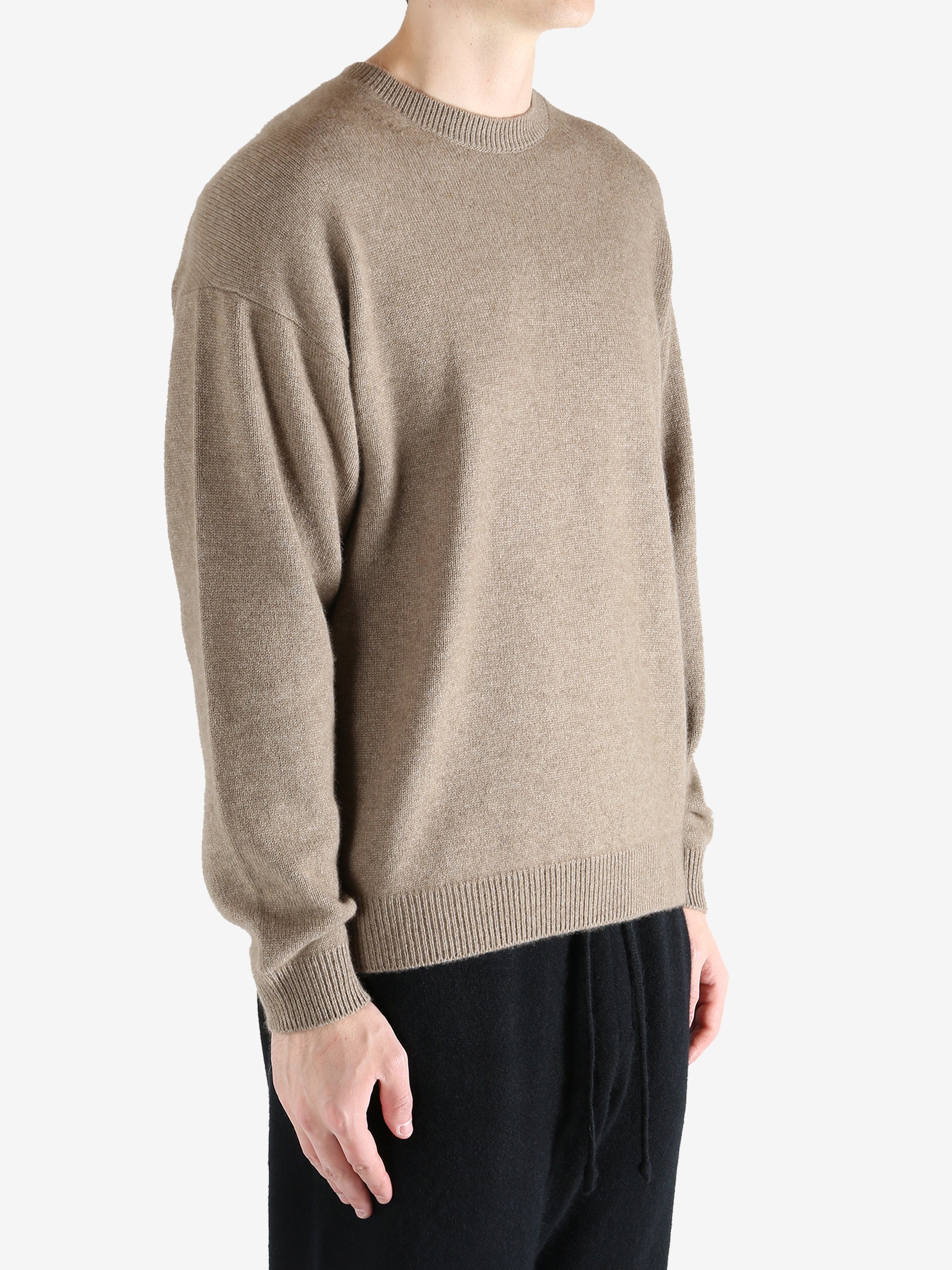 Brown knitwear worn by a person, showing the knitwear's fit