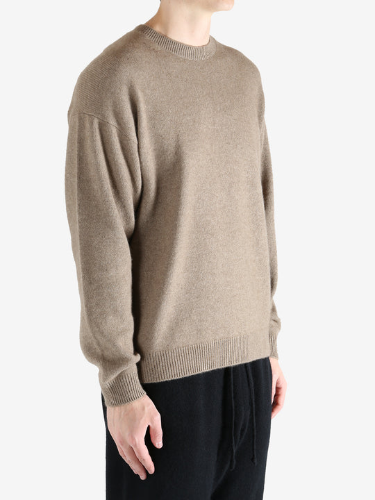 Brown knitwear worn by a person, showing the knitwear's fit