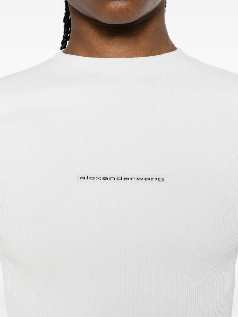 White top worn by a person, showing the top fit