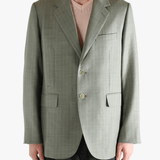 Green jacket worn by a person, showing the jacket's fit