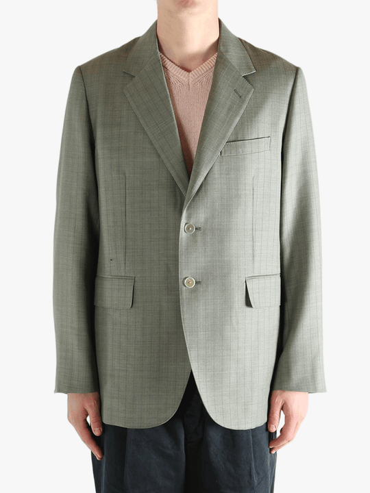 Green jacket worn by a person, showing the jacket's fit