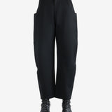 Black pants worn by a person, showing the pants' fit