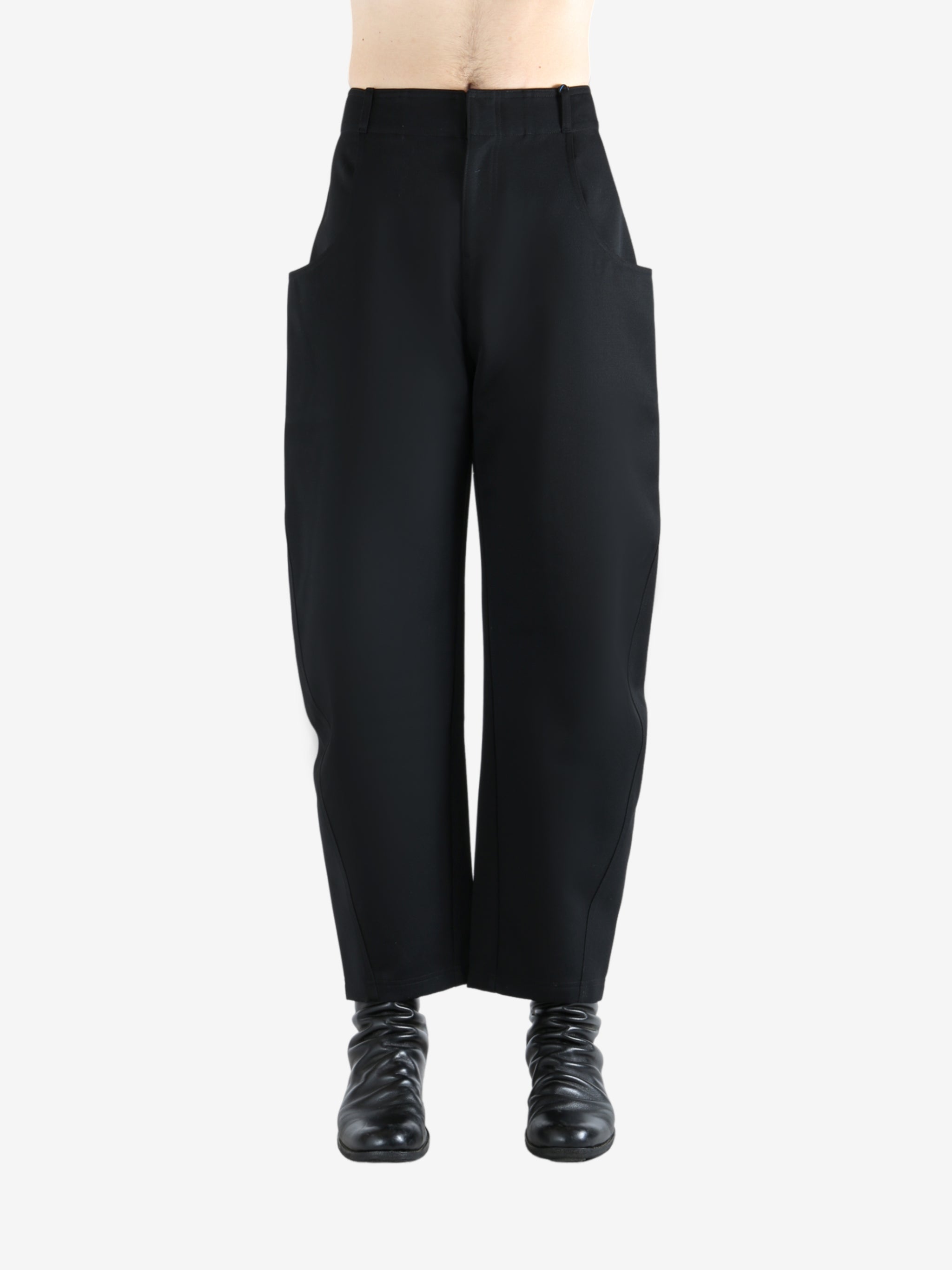 Black pants worn by a person, showing the pants' fit