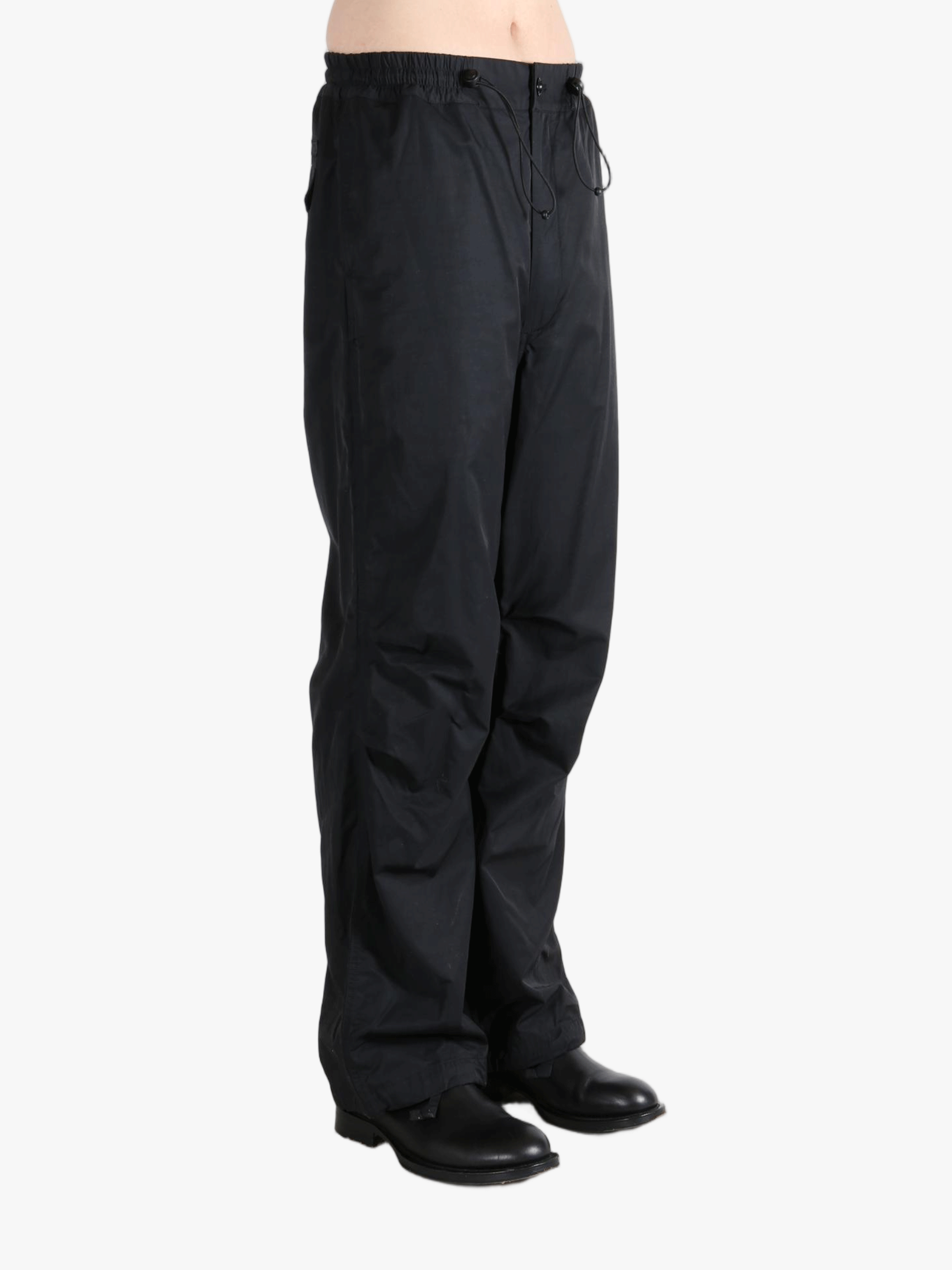 Black pants  worn by a person, showing the pants fit