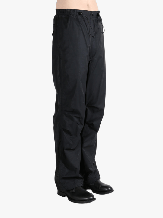 Black pants  worn by a person, showing the pants fit
