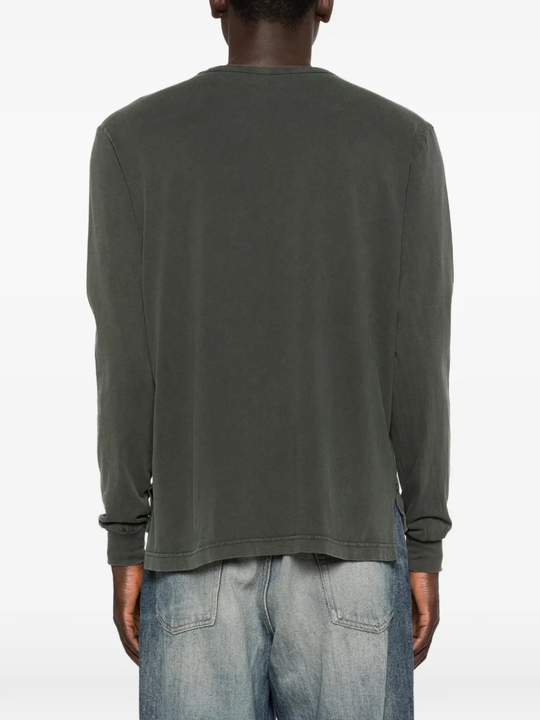 Grey knitwear worn by a person, showing the knitwear's fit