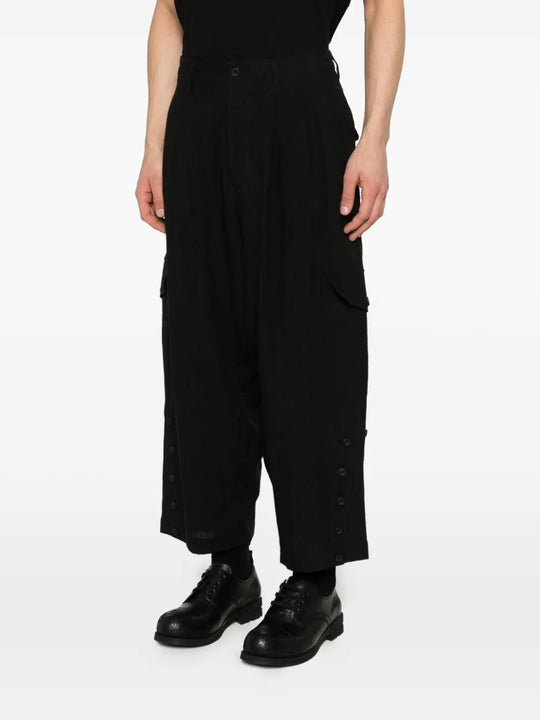 Black pants worn by a person, showing the pants's fit