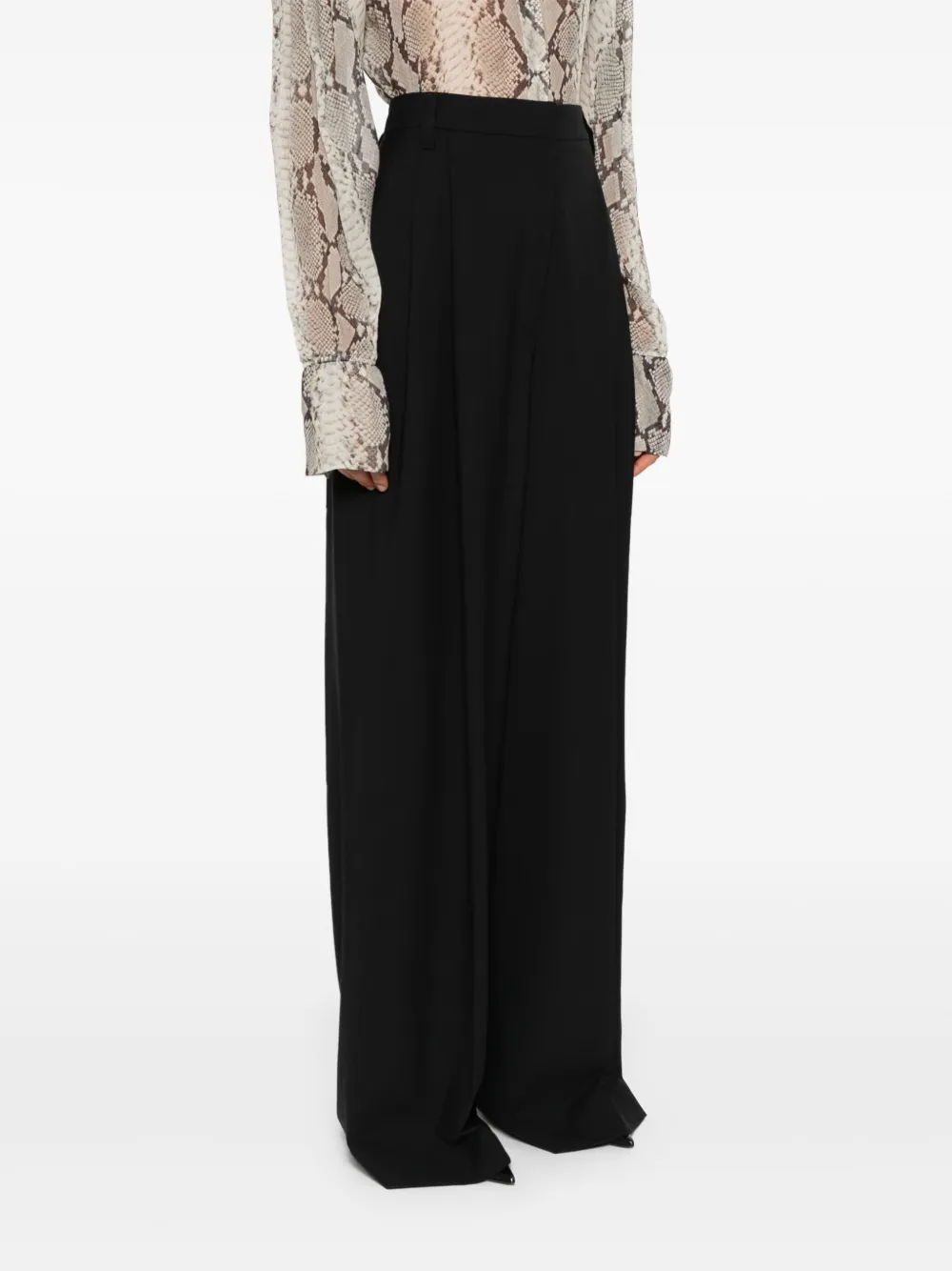 Black pants worn by a person, showing the pants fit