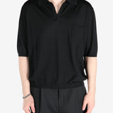 Black T-shirt worn by a person, showing the shirt’s fit