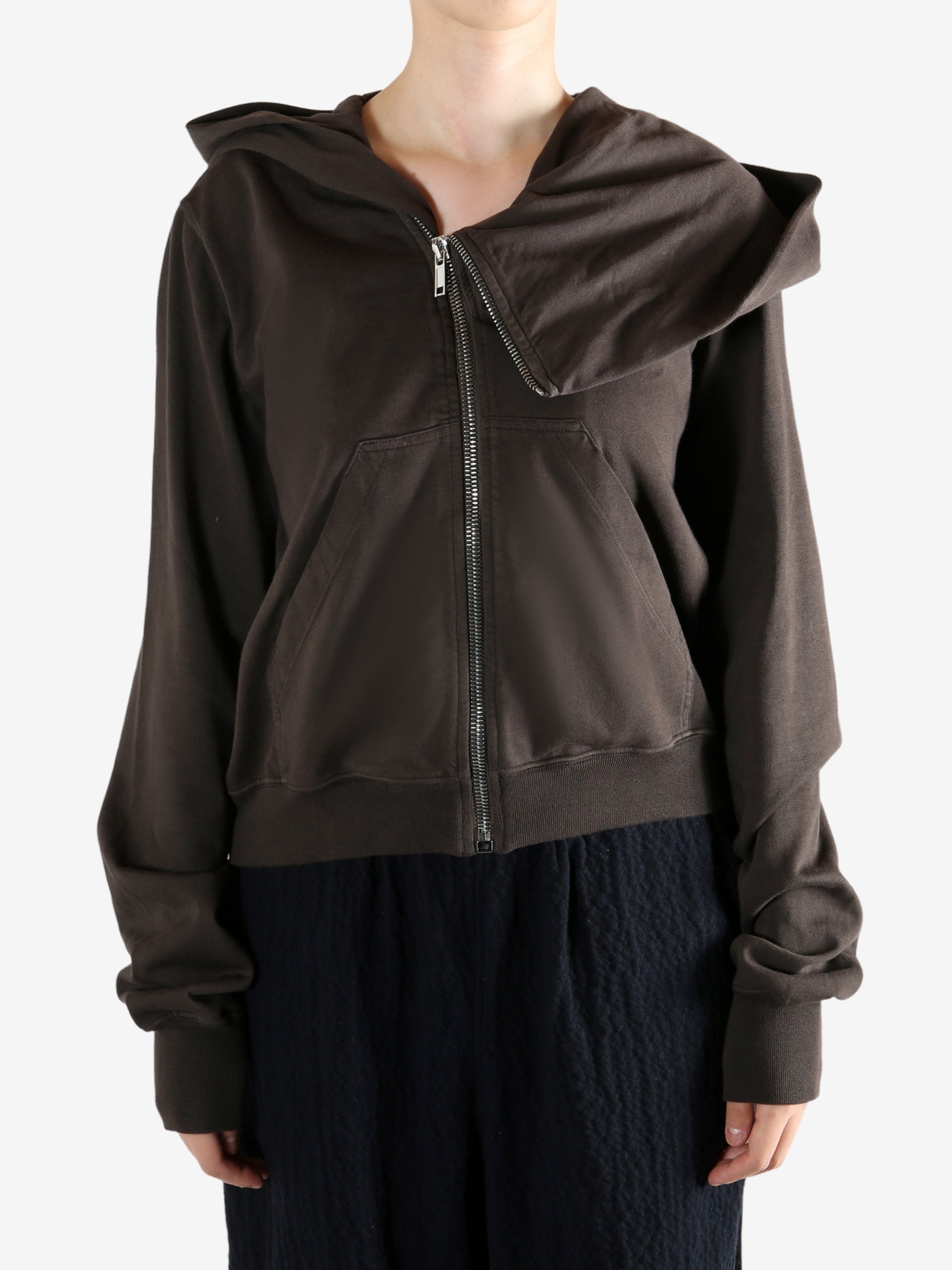 Brown hoodie worn by a person, showing the hoodie's fit