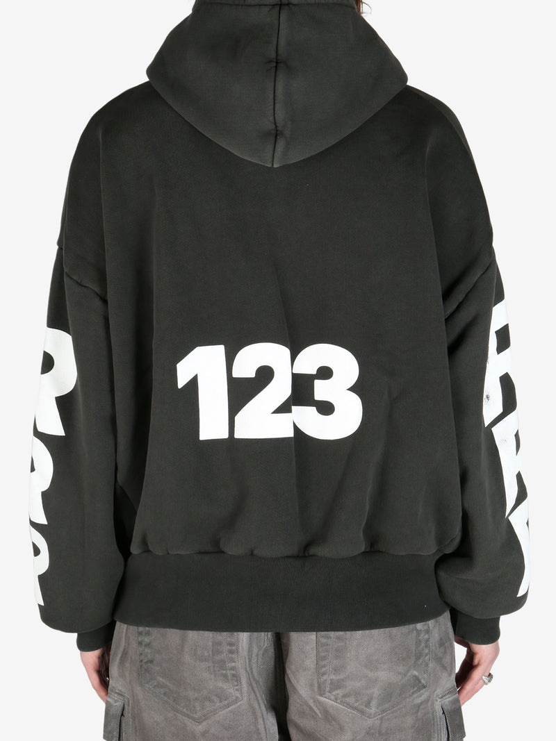 Black hoodie worn by a person, showing the hoodie's fit