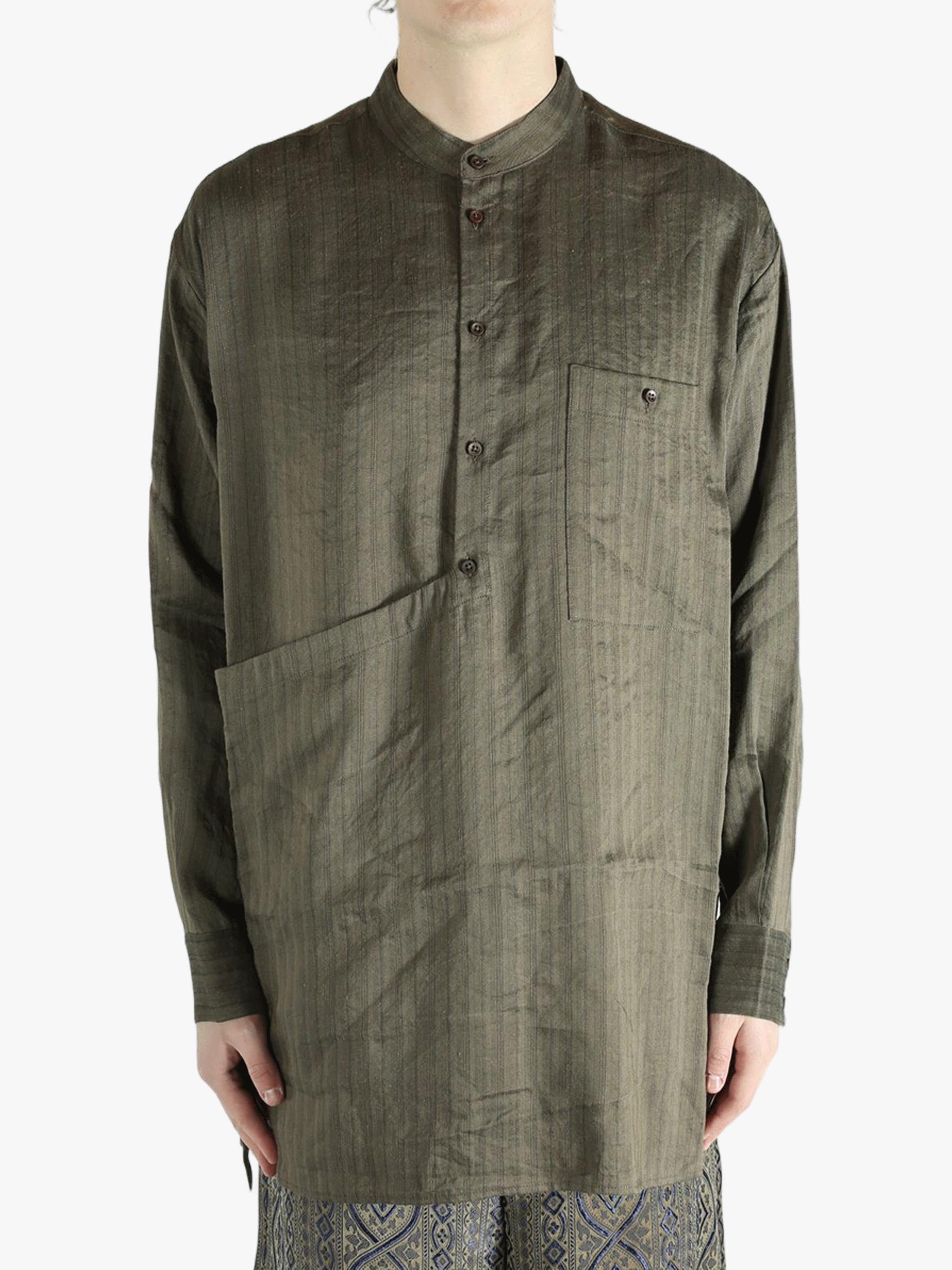 Grey top worn by a person, showing the top's fit