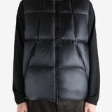 Black vest worn by a person, showing the vest  fit