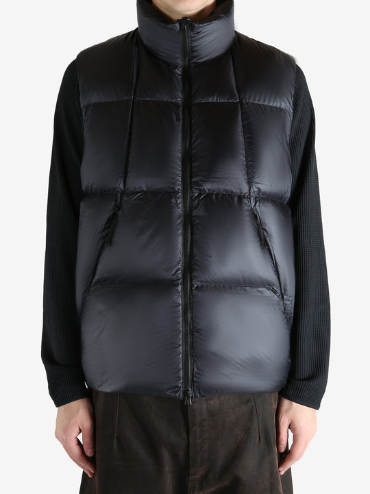 Black vest worn by a person, showing the vest  fit