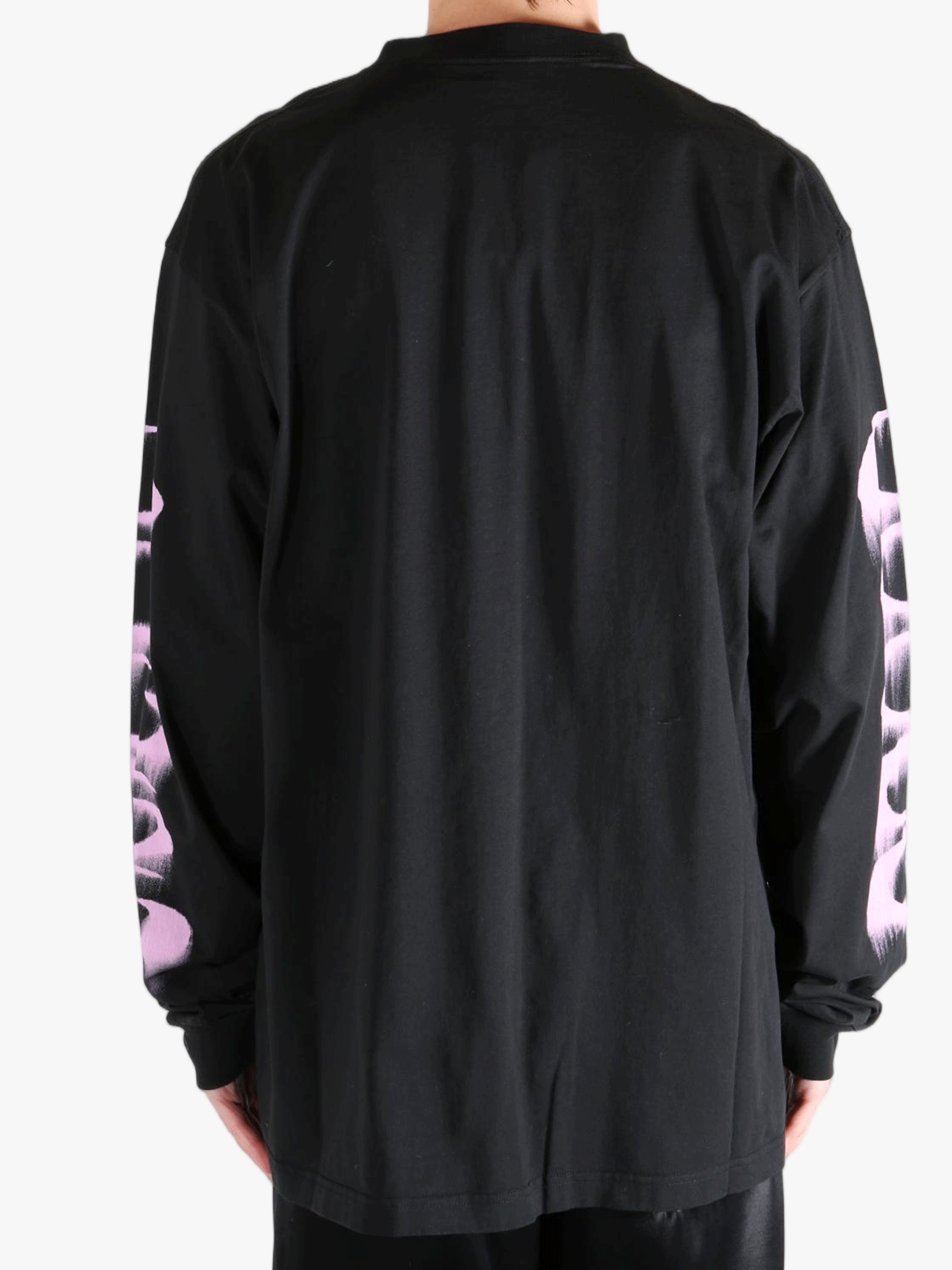 Black shirt worn by a person, showing the shirt's fit