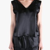 Black top worn by a person, showing the top's fit