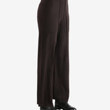 Black pants worn by a person, showing the pants fit