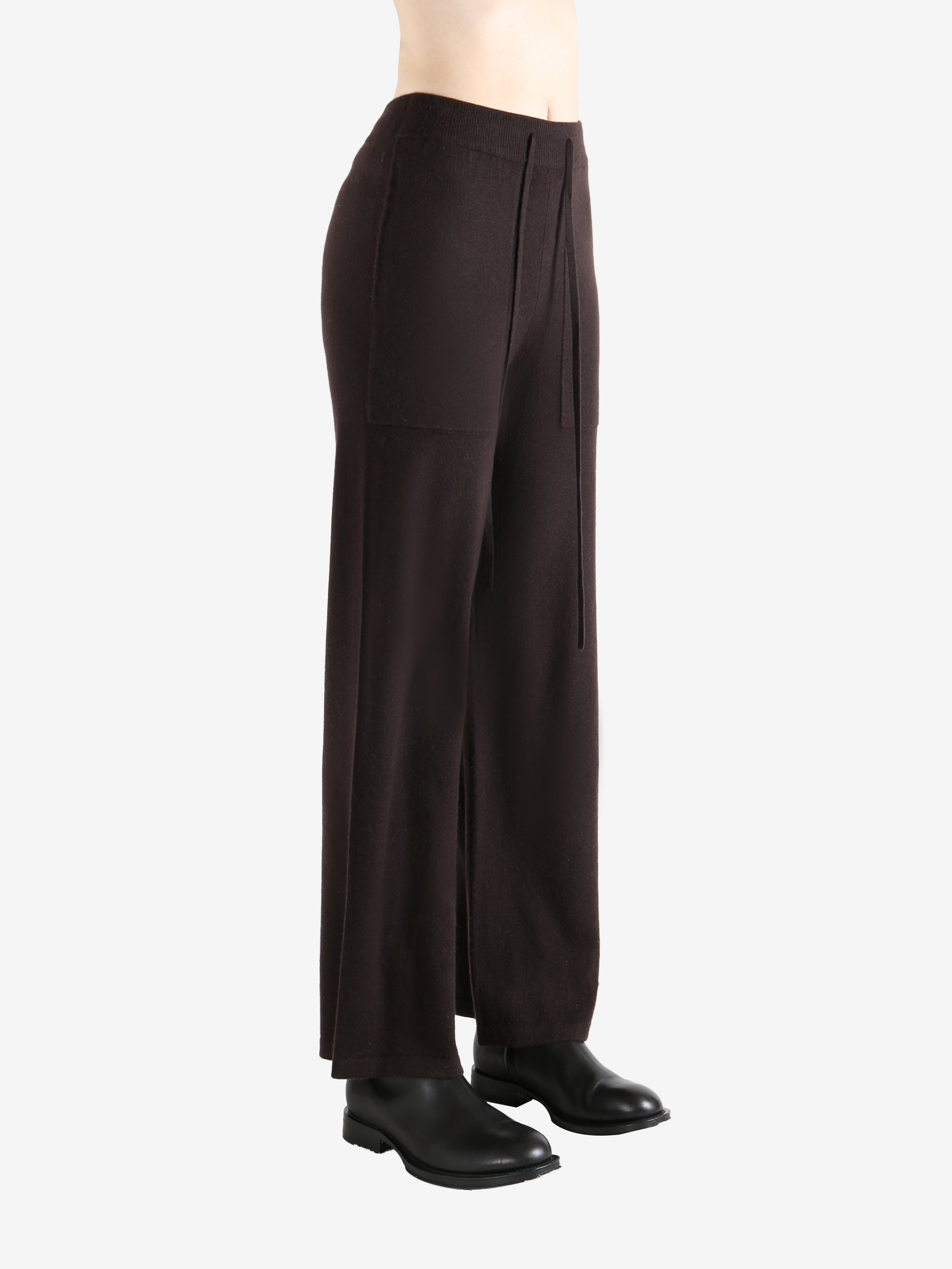 Black pants worn by a person, showing the pants fit