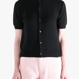 Black knitwear worn by a person, showing the knitwear's fit