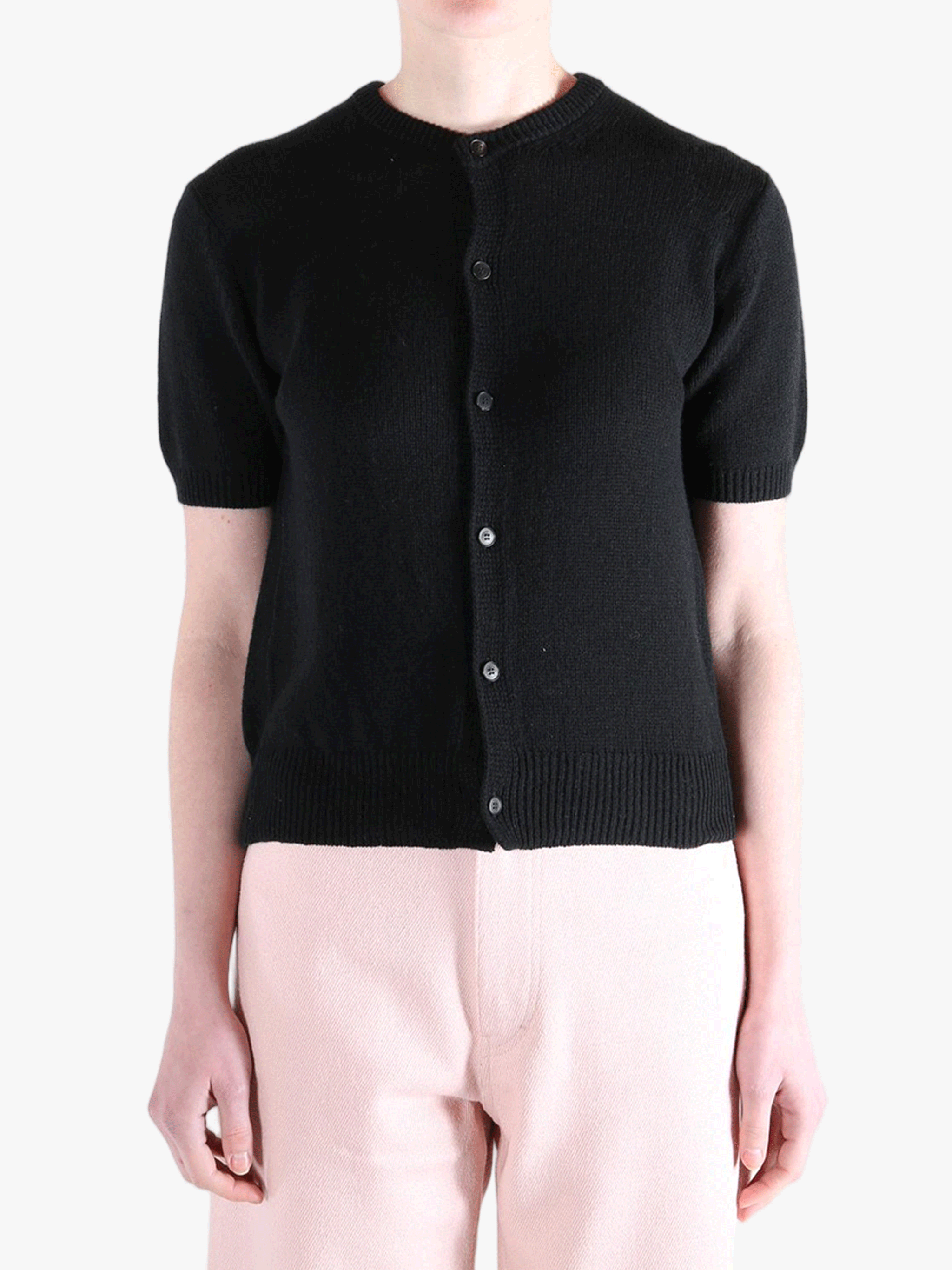 Black knitwear worn by a person, showing the knitwear's fit