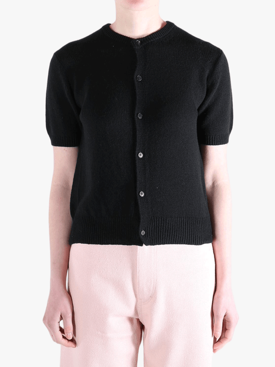 Black knitwear worn by a person, showing the knitwear's fit