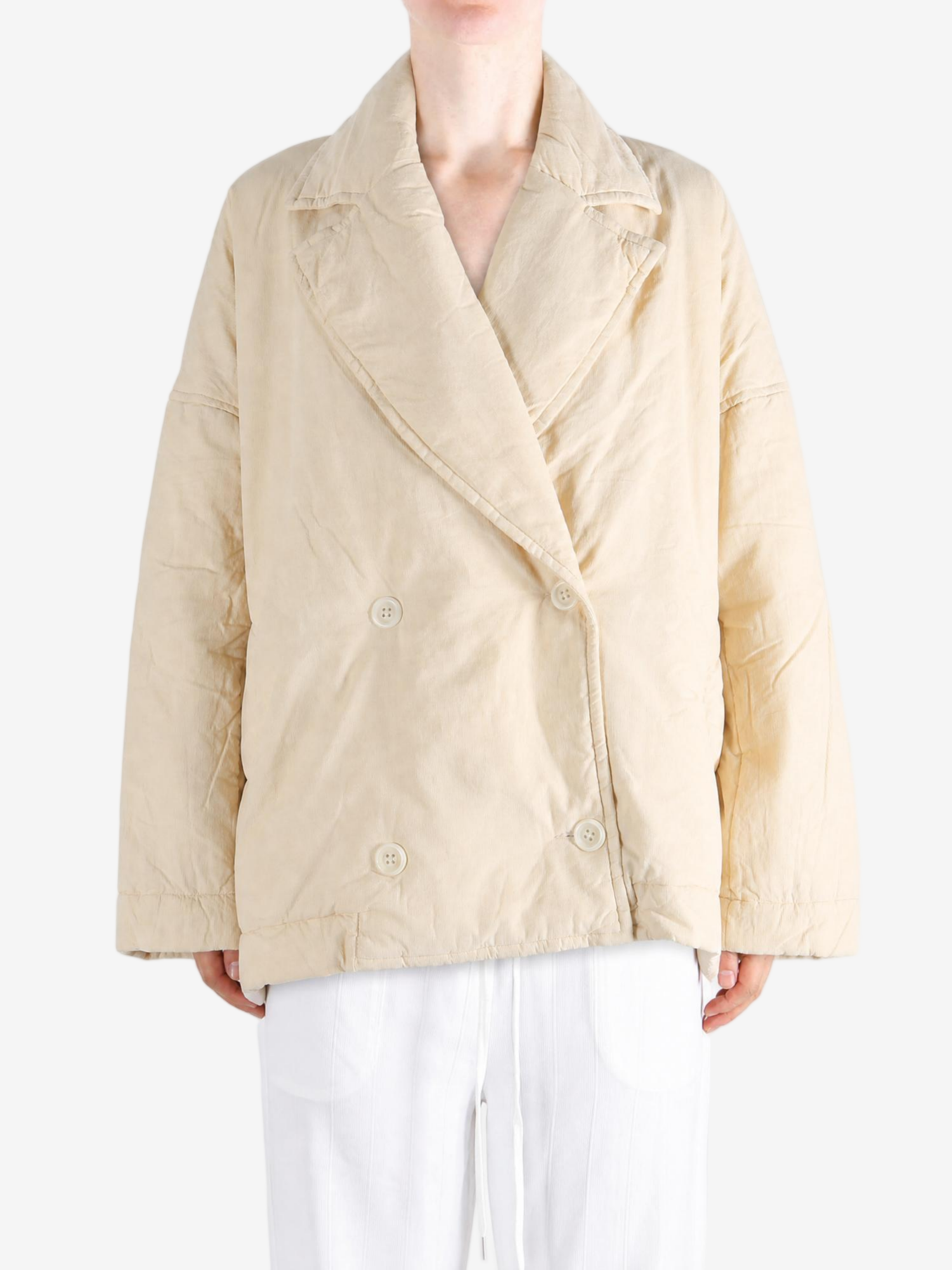 Tan jacket worn by a person, showing the jacket fit