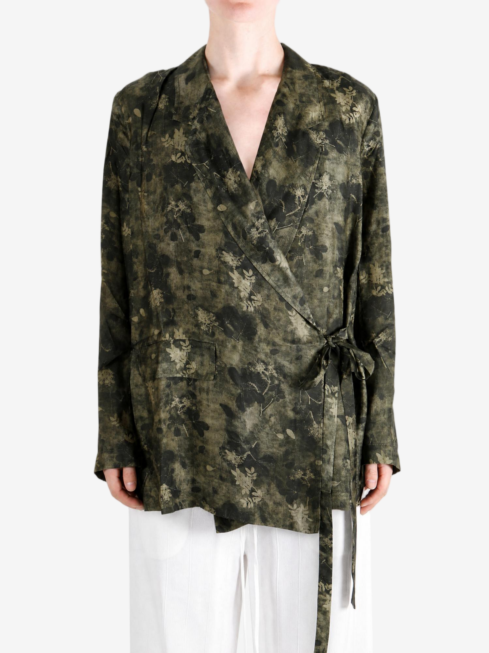 Green jacket worn by a person, showing the jacket fit