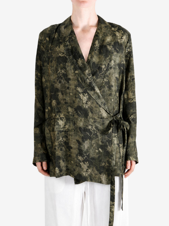 Green jacket worn by a person, showing the jacket fit