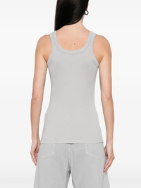 Grey tops worn by a person, showing the tops fit