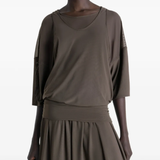 Close up of brown dresses, showing texture of the nylon fabric