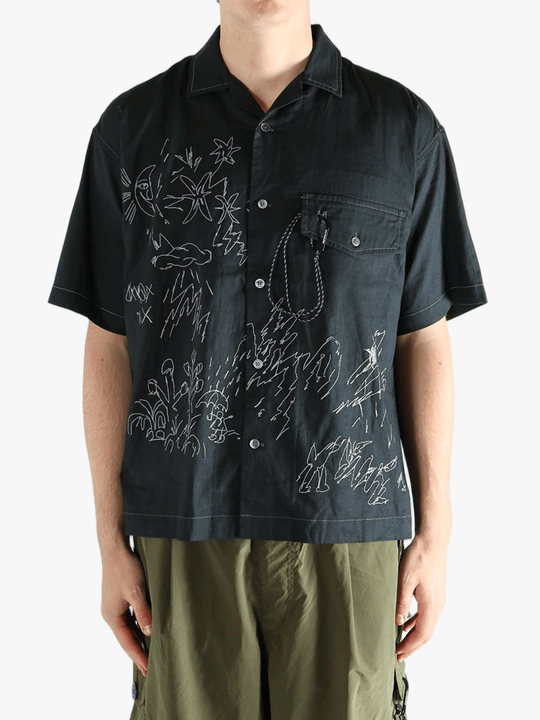 Black shirts worn by a person, showing the shirts fit