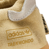 Close up of tan sneakers, showing texture of the suede fabric