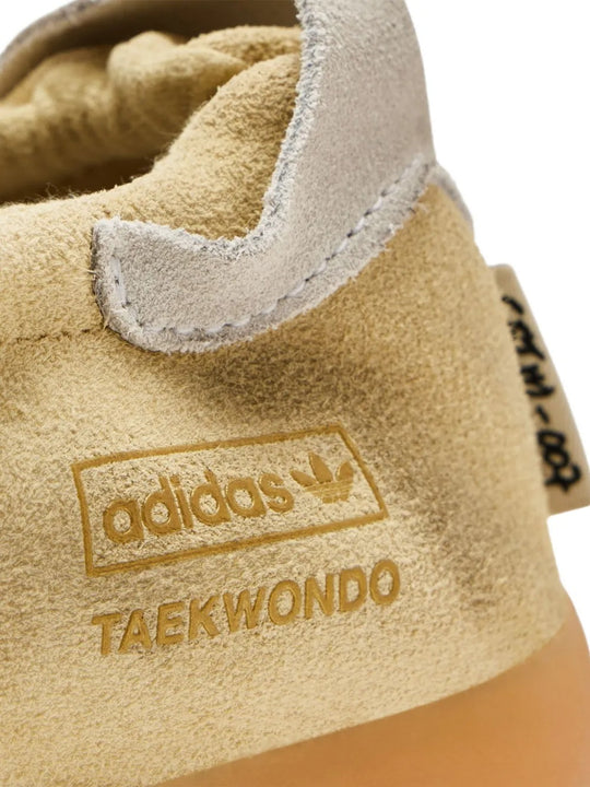 Close up of tan sneakers, showing texture of the suede fabric