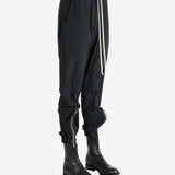 Black pant worn by a person, showing the pant's fit