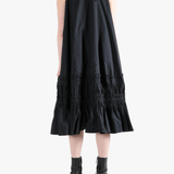Black dress worn by a person, showing the dress's fit
