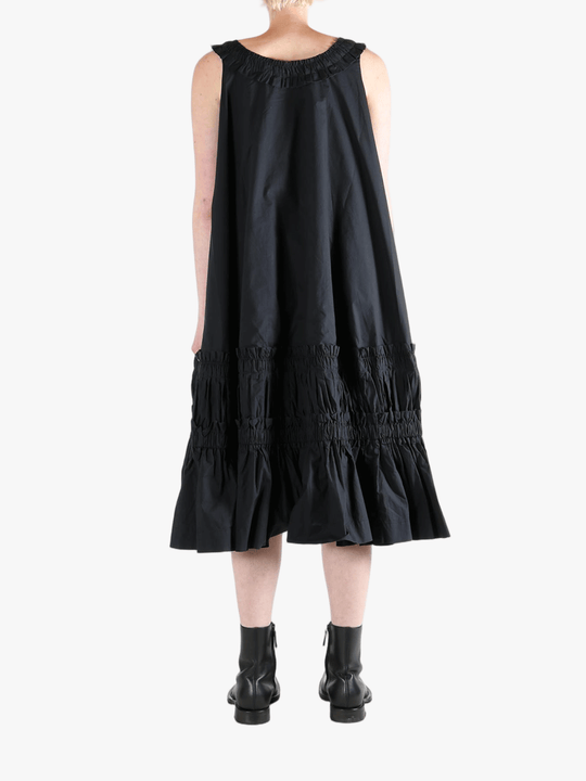 Black dress worn by a person, showing the dress's fit