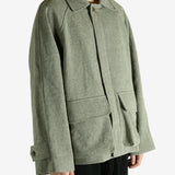 Green jacket worn by a person, showing the jacket fit