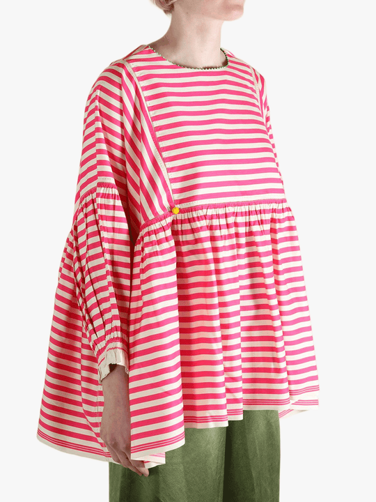 Red top worn by a person, showing the top's fit