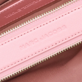 close up of pink bags, showing texture of the leather fabric