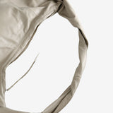 Close up of the tan bag, showing texture of the leather fabric