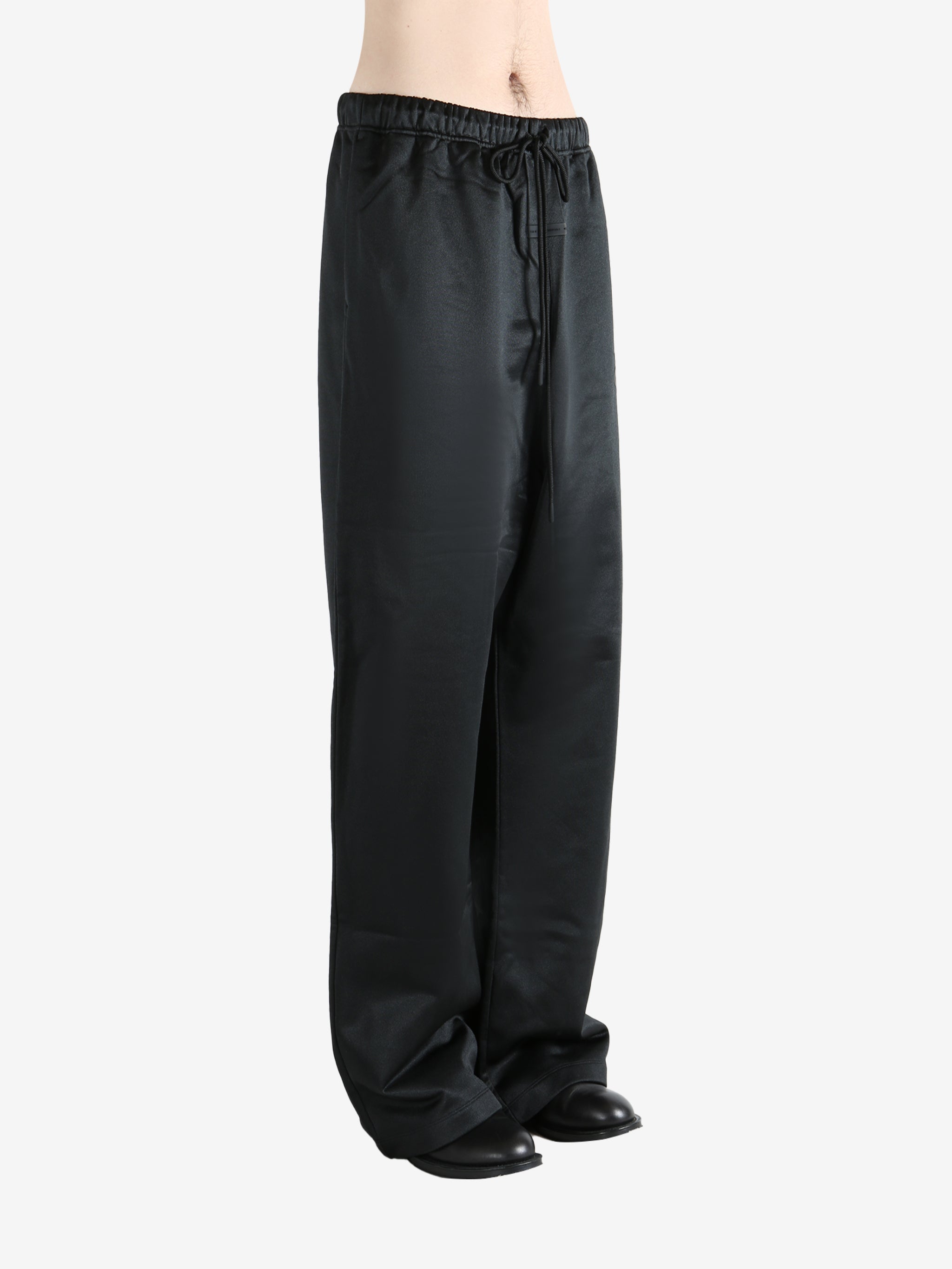 Black pants worn by a person, showing the pants fit