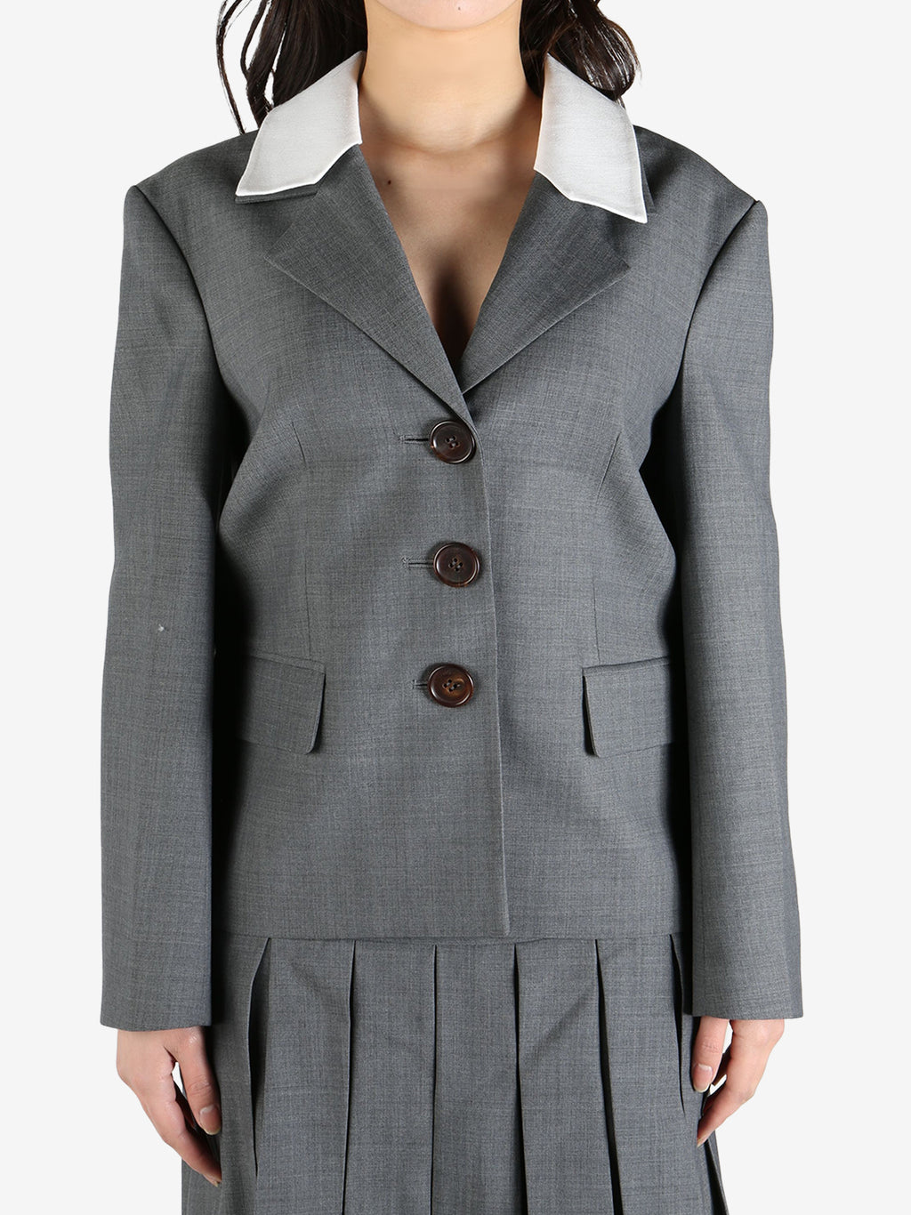 Grey blazer worn by a person, showing the blazer's fit